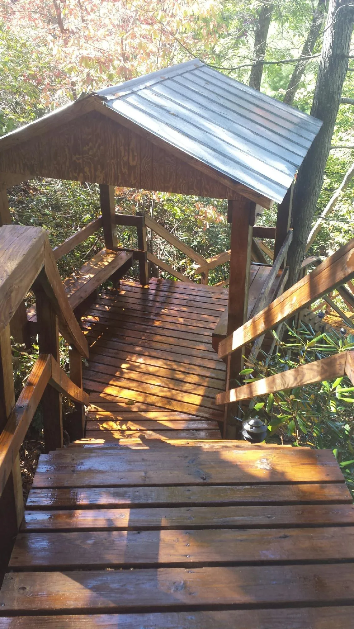 Freshly stained wood walkway and covered shelter with a metal roof in Belen
